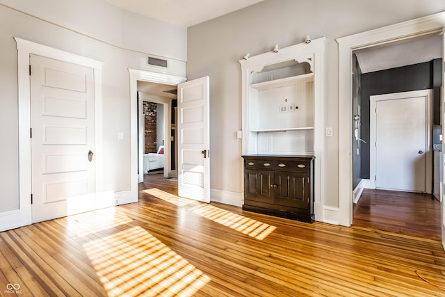 unfurnished bedroom featuring hardwood / wood-style flooring