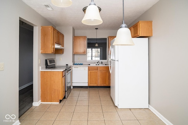 kitchen featuring sink, pendant lighting, a textured ceiling, and white appliances