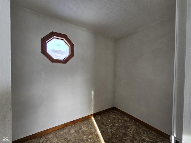 empty room featuring a textured ceiling