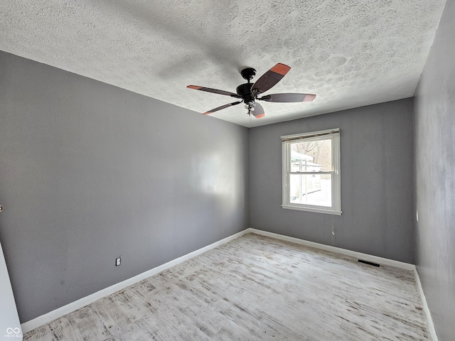 unfurnished room featuring a textured ceiling, ceiling fan, and light hardwood / wood-style floors