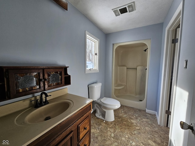 bathroom featuring a textured ceiling, toilet, walk in shower, and vanity