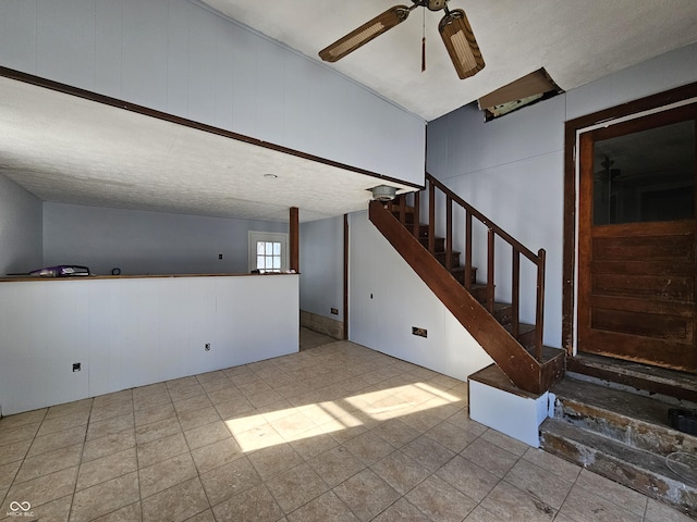 interior space featuring ceiling fan and a textured ceiling