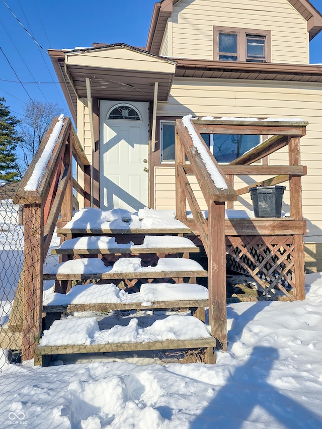 view of snow covered property entrance