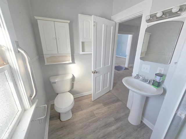 bathroom with toilet and hardwood / wood-style flooring