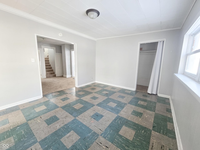 unfurnished bedroom with a closet and ornamental molding