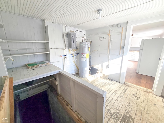 kitchen with hardwood / wood-style floors, water heater, white refrigerator, and electric panel