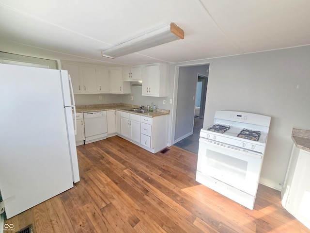 kitchen with white cabinetry, sink, light hardwood / wood-style flooring, and white appliances