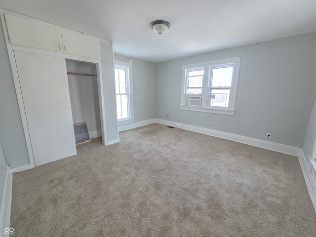 unfurnished bedroom featuring a closet, light colored carpet, and multiple windows