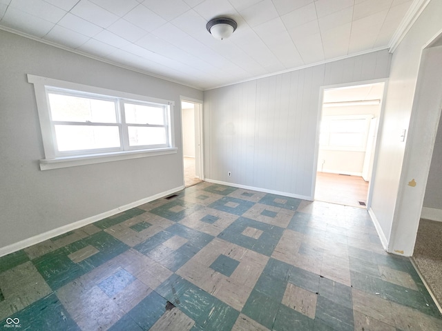 empty room featuring crown molding