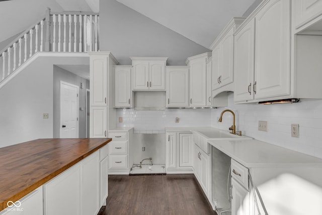 kitchen featuring tasteful backsplash, sink, dark hardwood / wood-style flooring, white cabinets, and butcher block counters