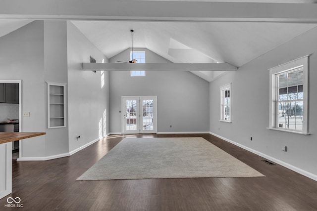 unfurnished living room with ceiling fan, dark wood-type flooring, a wealth of natural light, and french doors