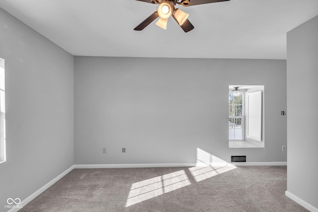 spare room featuring ceiling fan and light colored carpet