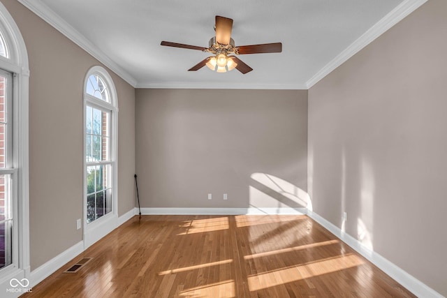 unfurnished room with ceiling fan, wood-type flooring, and crown molding