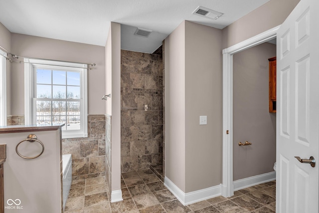 bathroom featuring vanity, tile walls, and independent shower and bath