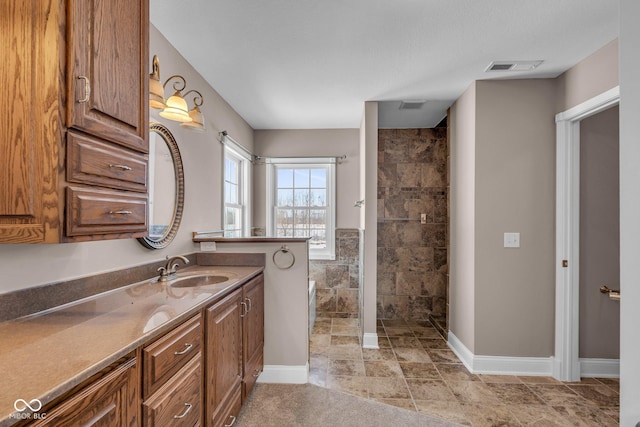 bathroom featuring walk in shower, vanity, and tile walls