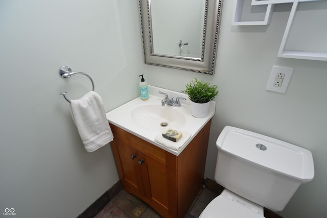 bathroom featuring toilet and vanity