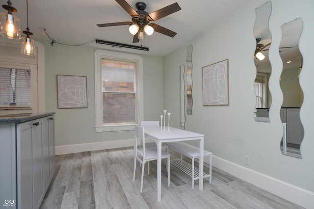 dining space with light hardwood / wood-style floors and ceiling fan