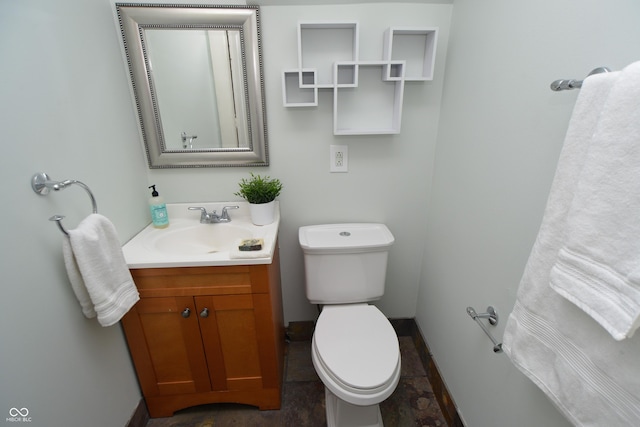 bathroom with toilet and vanity