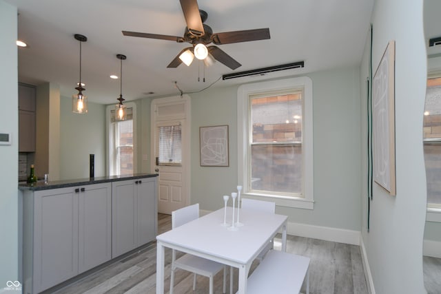 dining space featuring ceiling fan and light hardwood / wood-style flooring