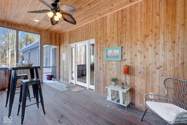 wooden deck featuring ceiling fan and exterior bar