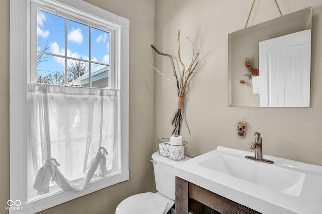 bathroom featuring toilet and vanity