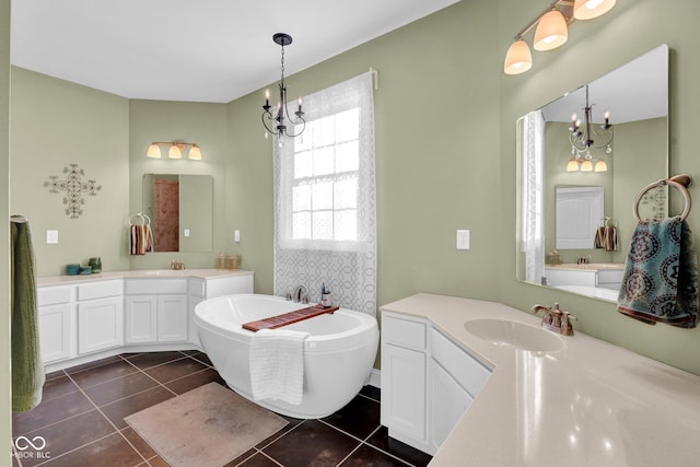 bathroom with a tub, vanity, and tile patterned flooring