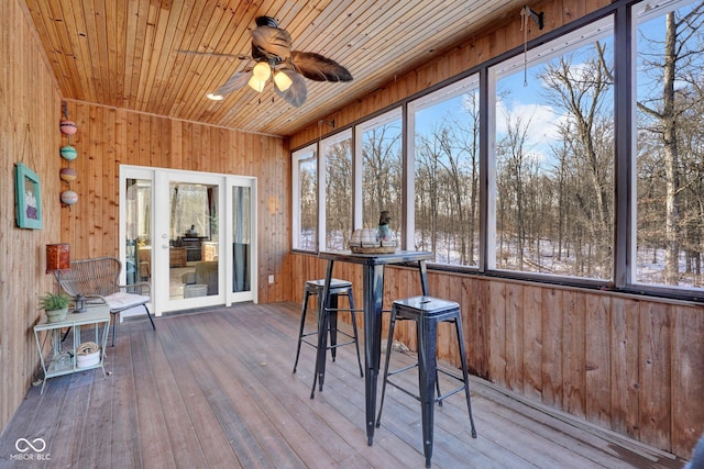 unfurnished sunroom with wooden ceiling and ceiling fan