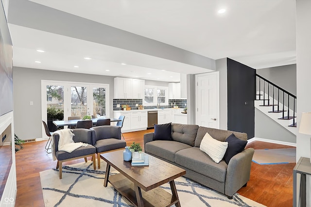 living room with sink and light hardwood / wood-style flooring