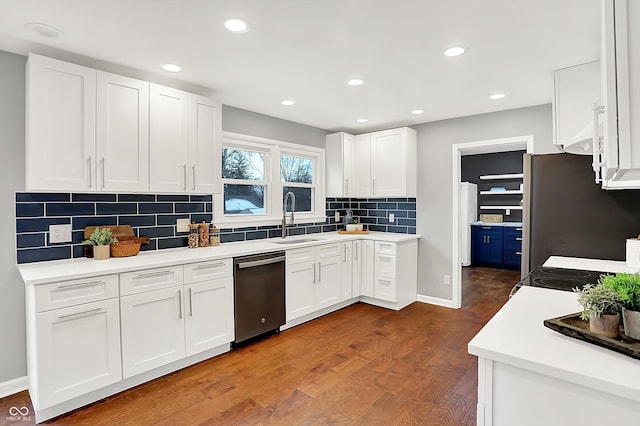 kitchen with dark hardwood / wood-style flooring, sink, stainless steel appliances, and white cabinetry