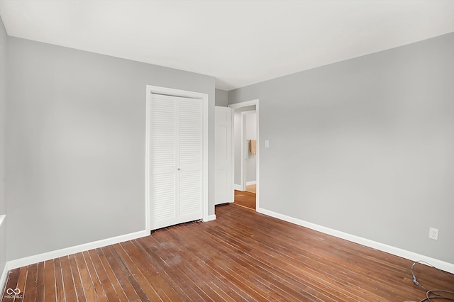 unfurnished bedroom featuring a closet and wood-type flooring