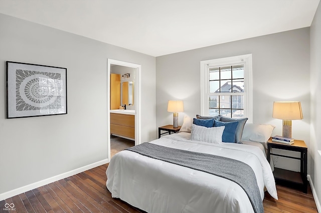 bedroom with ensuite bathroom and dark hardwood / wood-style floors