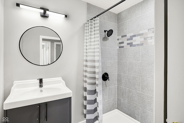 bathroom featuring curtained shower and vanity