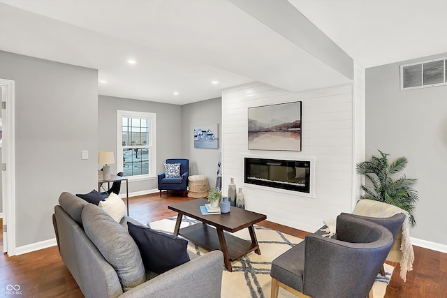 living room with a fireplace and dark hardwood / wood-style flooring