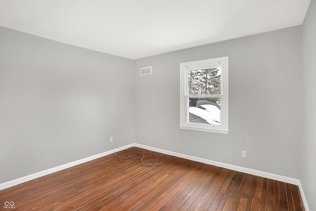 spare room with wood-type flooring