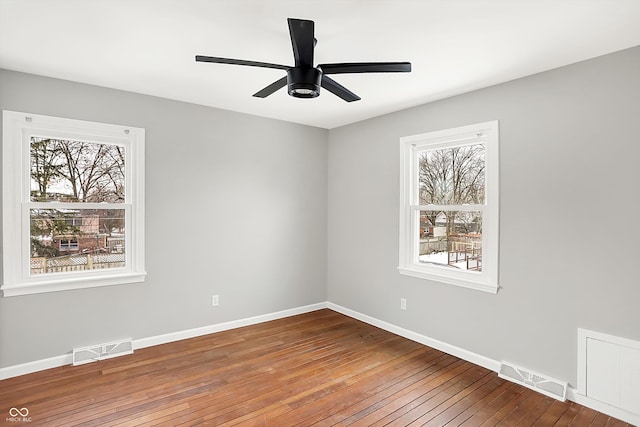 unfurnished room with ceiling fan, plenty of natural light, and hardwood / wood-style floors