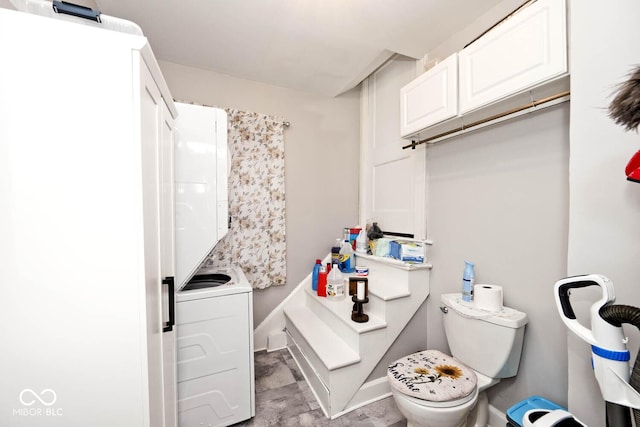 bathroom with toilet and stacked washing maching and dryer