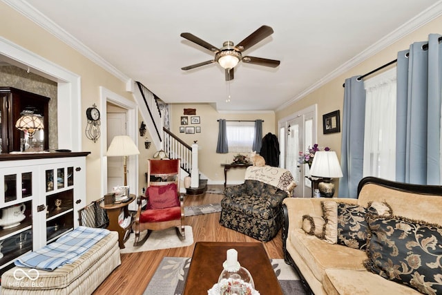 living room with ceiling fan, wood-type flooring, french doors, and crown molding