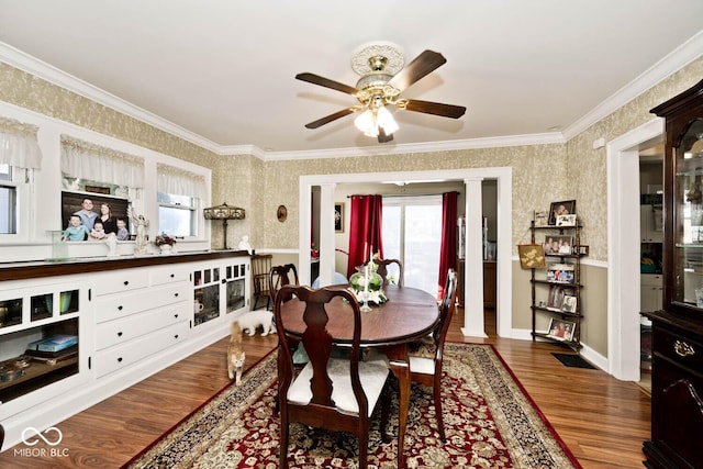 dining area with ceiling fan, crown molding, ornate columns, and hardwood / wood-style flooring