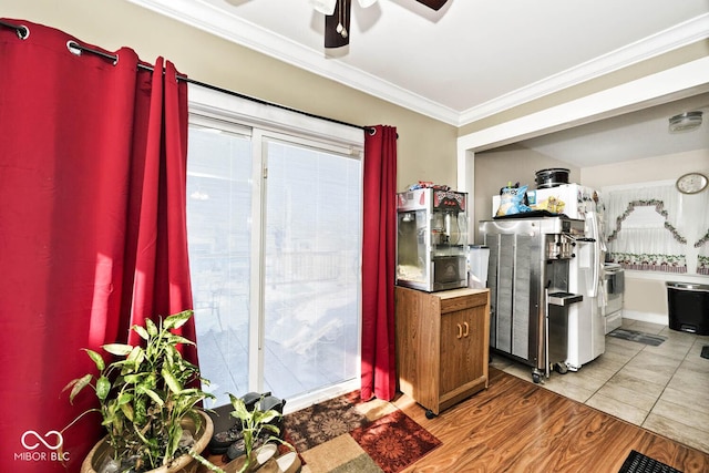 kitchen with ceiling fan, ornamental molding, and light hardwood / wood-style floors