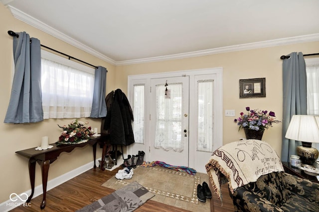 entrance foyer with dark hardwood / wood-style flooring and crown molding