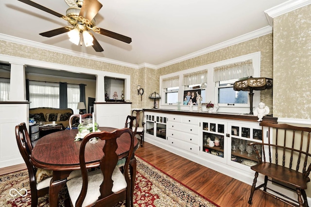 dining space featuring ceiling fan, wood-type flooring, and crown molding