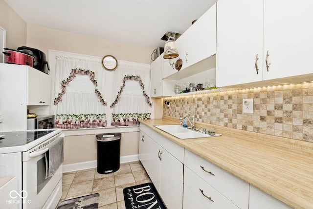 kitchen featuring decorative backsplash, sink, white cabinetry, and white range with electric cooktop