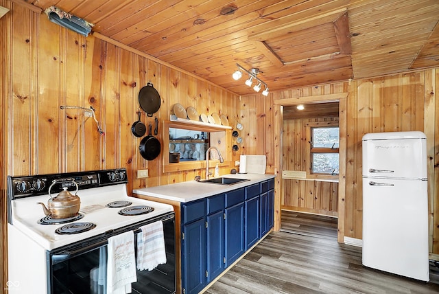 kitchen with electric range oven, blue cabinets, sink, white fridge, and wood ceiling