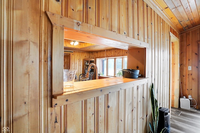 kitchen with wood-type flooring, wood ceiling, and wood walls