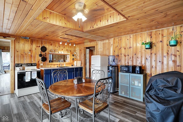 dining room with sink, dark wood-type flooring, and wooden ceiling