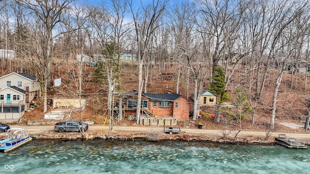 back of property with a water view