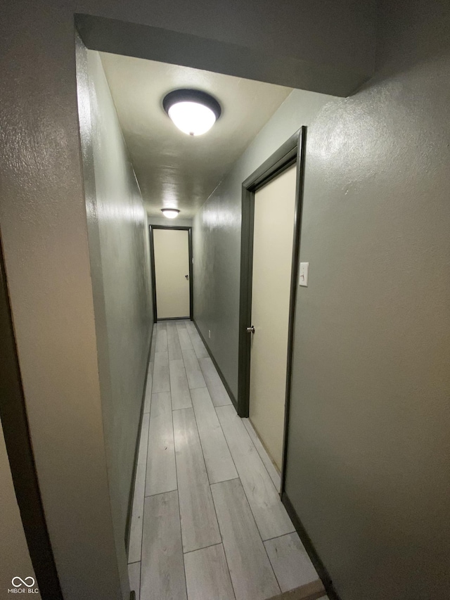 corridor with light hardwood / wood-style floors