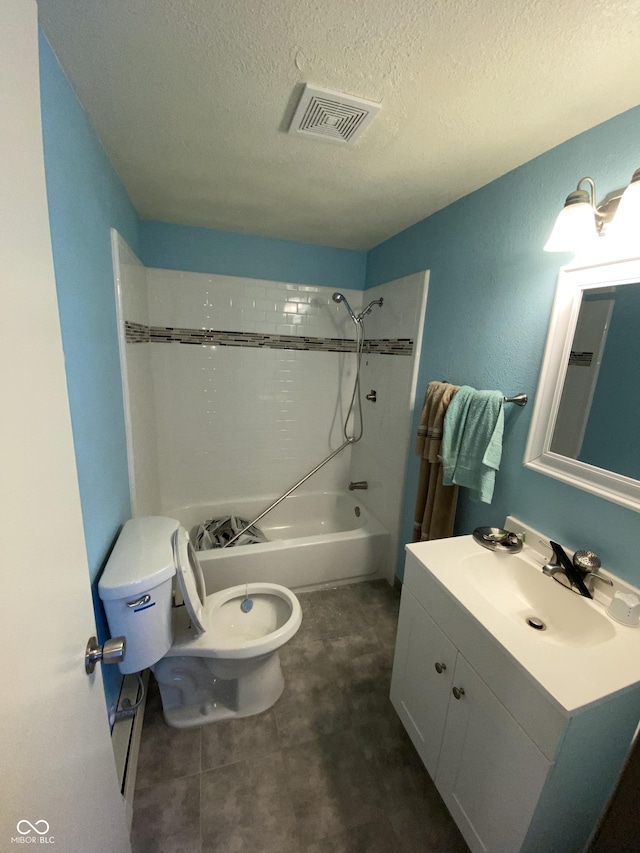 full bathroom featuring a textured ceiling, tiled shower / bath combo, vanity, and toilet