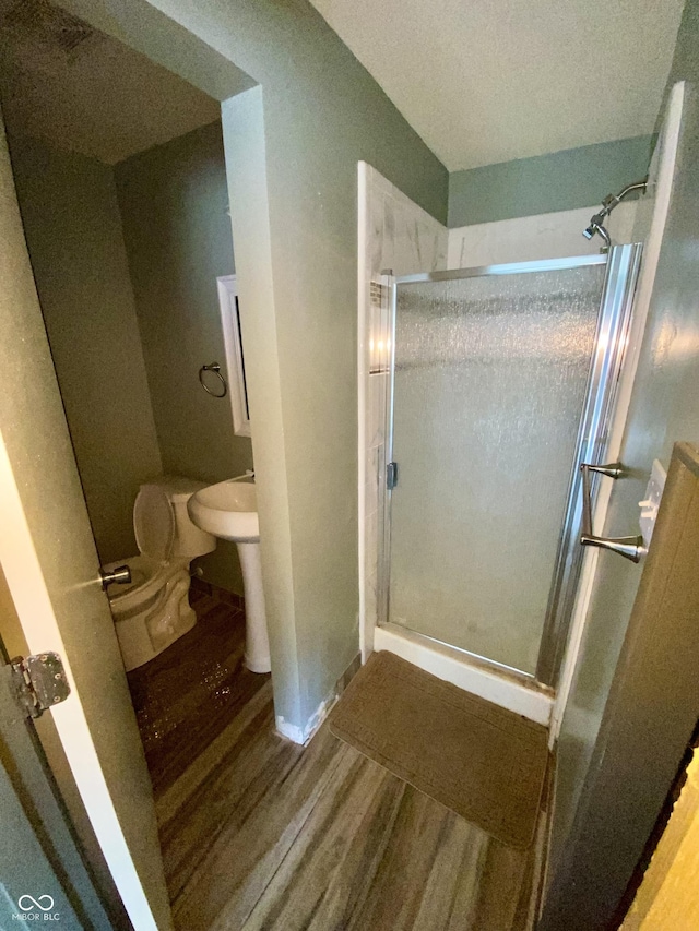 bathroom featuring hardwood / wood-style floors and an enclosed shower