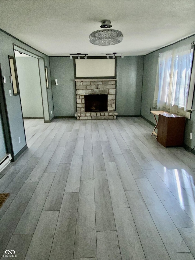 unfurnished living room featuring a textured ceiling and a stone fireplace